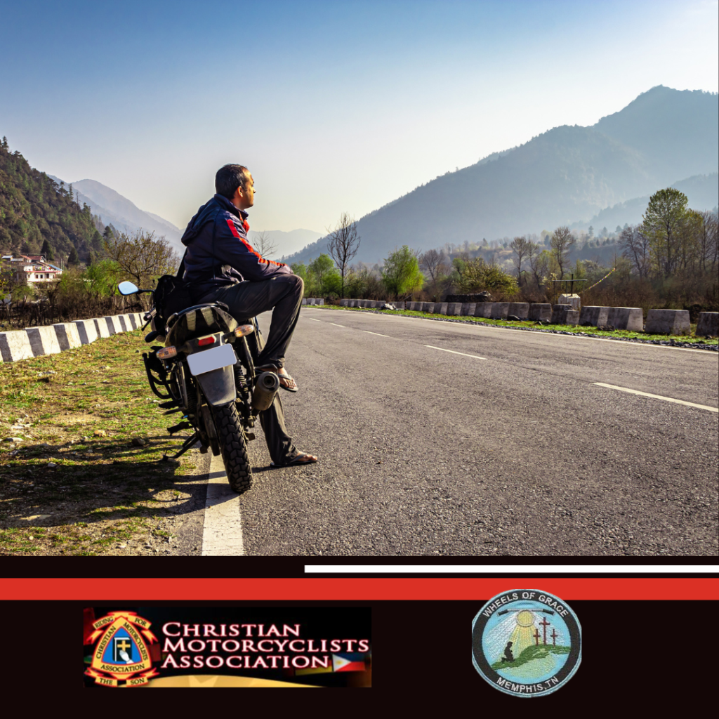 Man sitting on his motorcycle watching the mountains